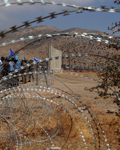 UN blue helmets are seen from a barbed wire representing the so-called Blue Line between Lebanon and Israel